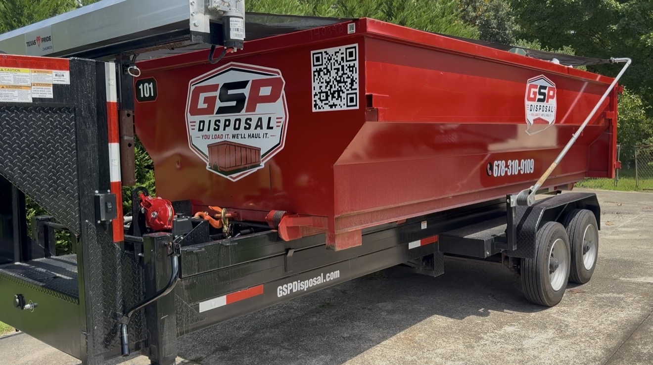 Real GSP Disposal 15-yard red dumpster secured on the delivery trailer