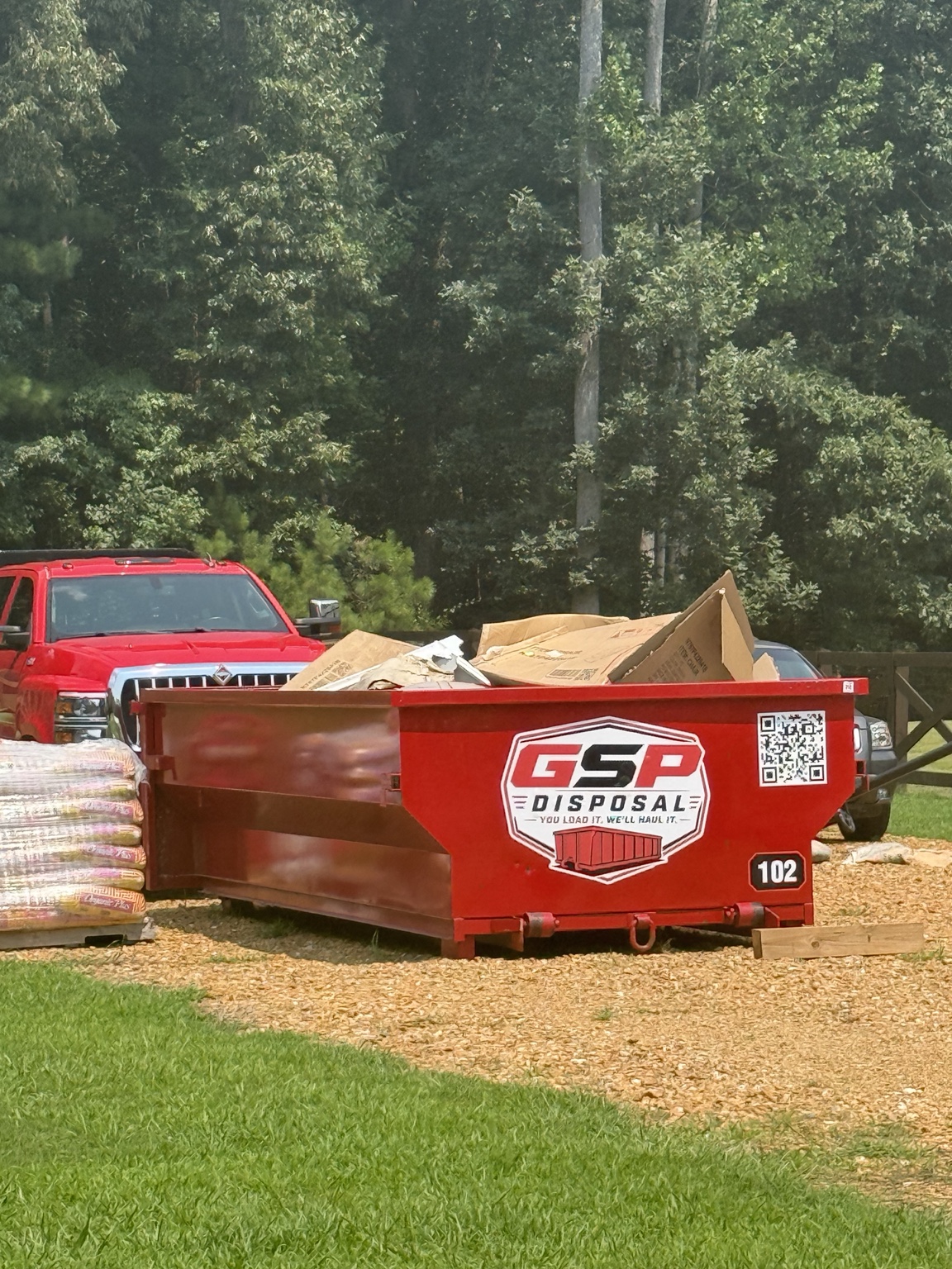 GSP dumpster with debris extending above the top rail, shown as an example of improper loading